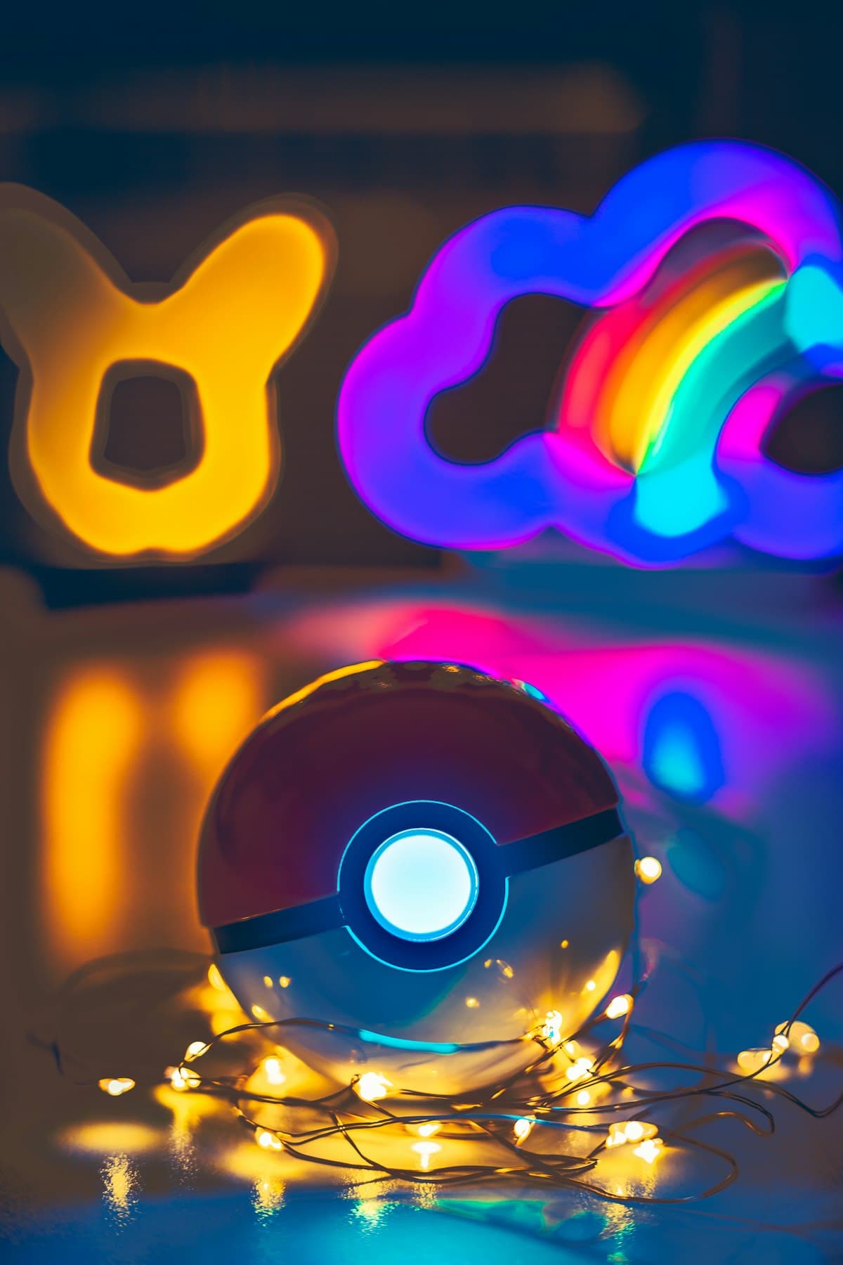 A glowing Poké Ball wrapped in string lights, with a neon Pikachu-ear lamp and a holographic disc in the background